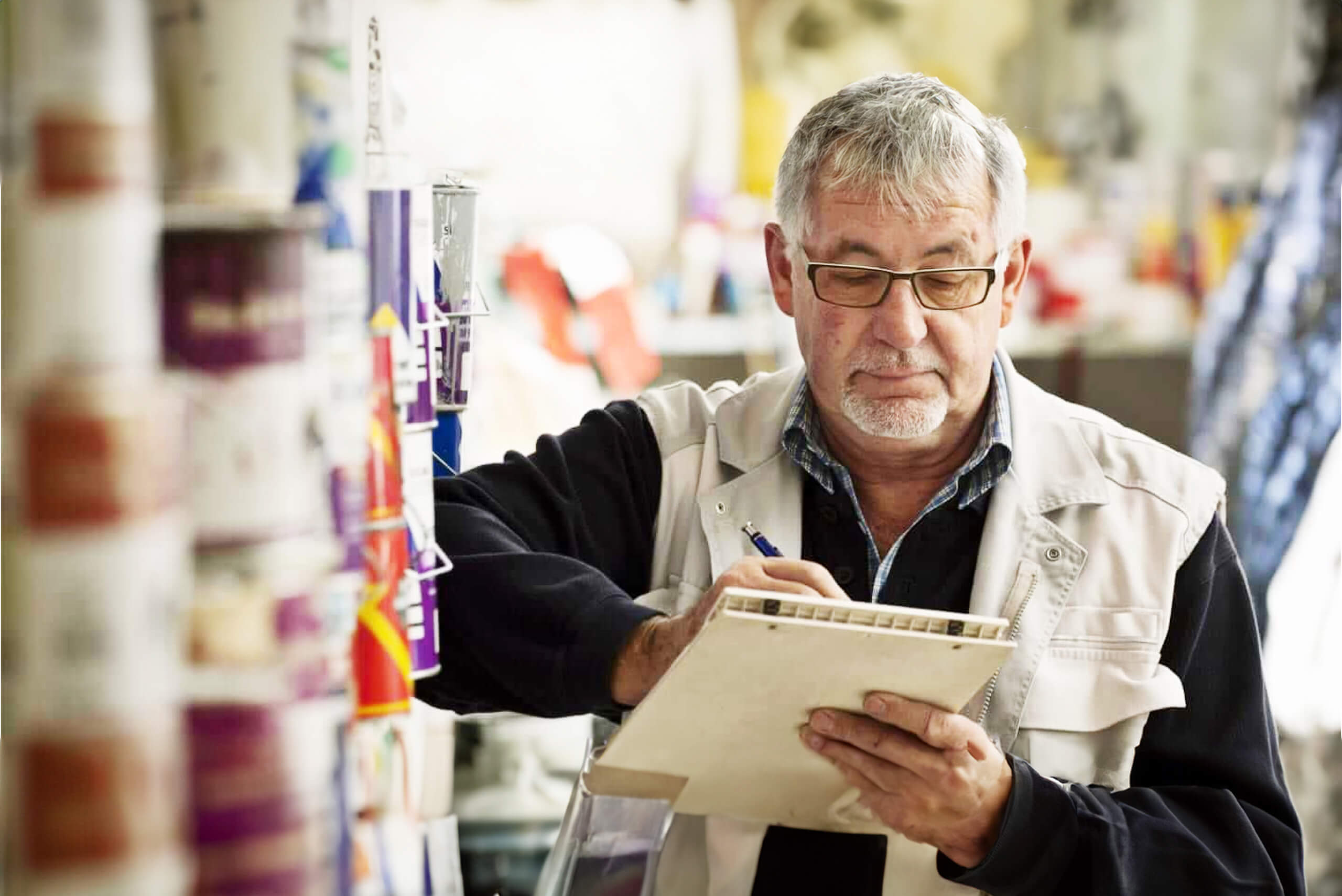 Man is writing down notes on a clipboard