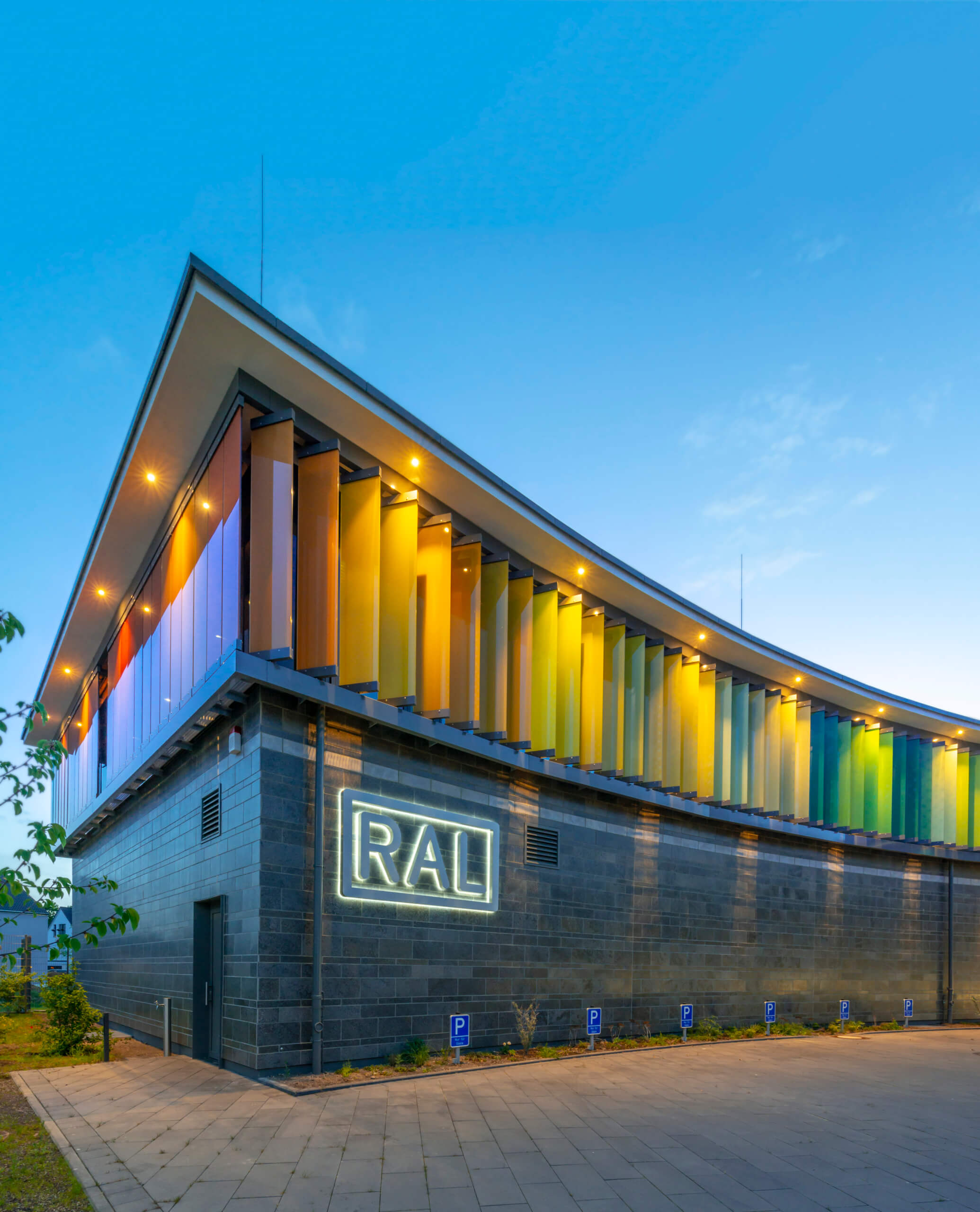 Softly lit RAL building at dusk